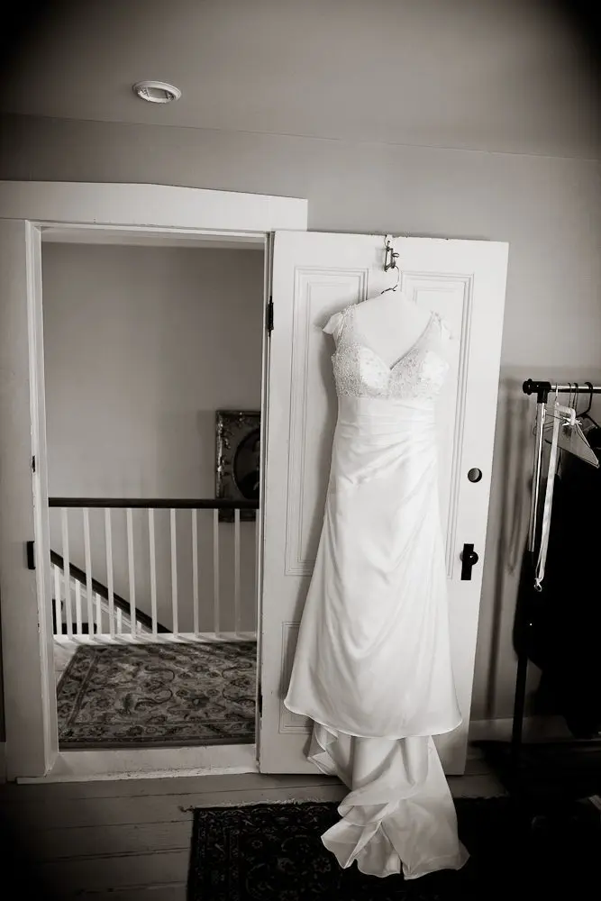 the wedding dress artistic shot of wedding dress hanging on door