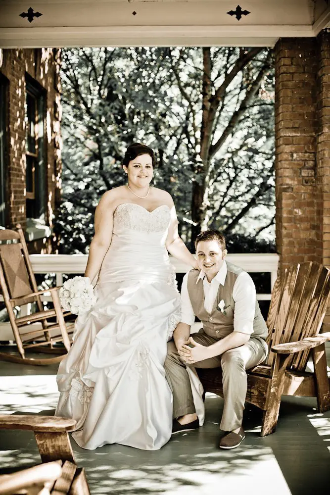 bride and groom formal shot groom sitting bride standing photograph