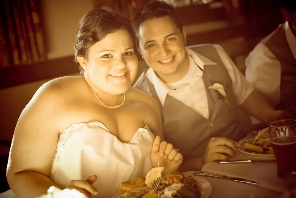 bride and groom at their table a cute shot of the couple before they eat dinner