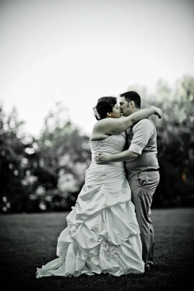 full length shot of bride and groom couple kissing during formal photos