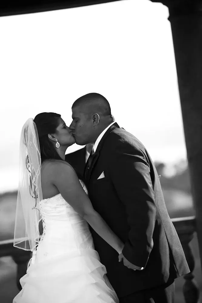 bride and groom kissing for the 1st time during the ceremony
