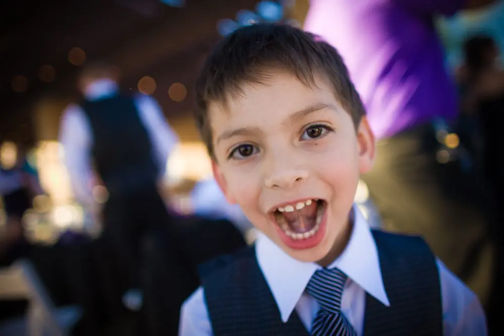 little groomsman in suit being goofy