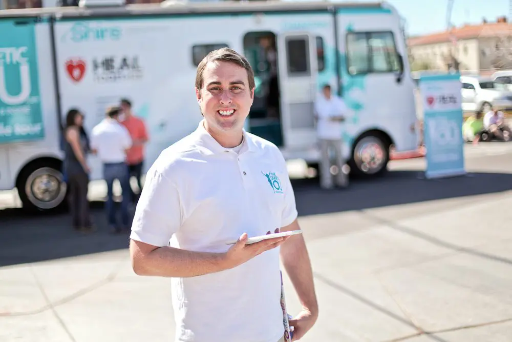 Shire rep holding ipad in front of the shire bus