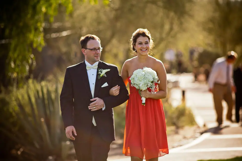 maid of honor and best man The maid of honor and best man smiling before walking down the aisle