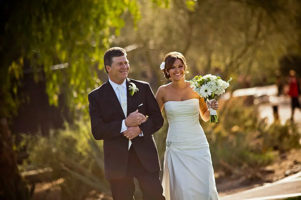 The bride and father of the bride bride and her father smiling before walking down the aisle