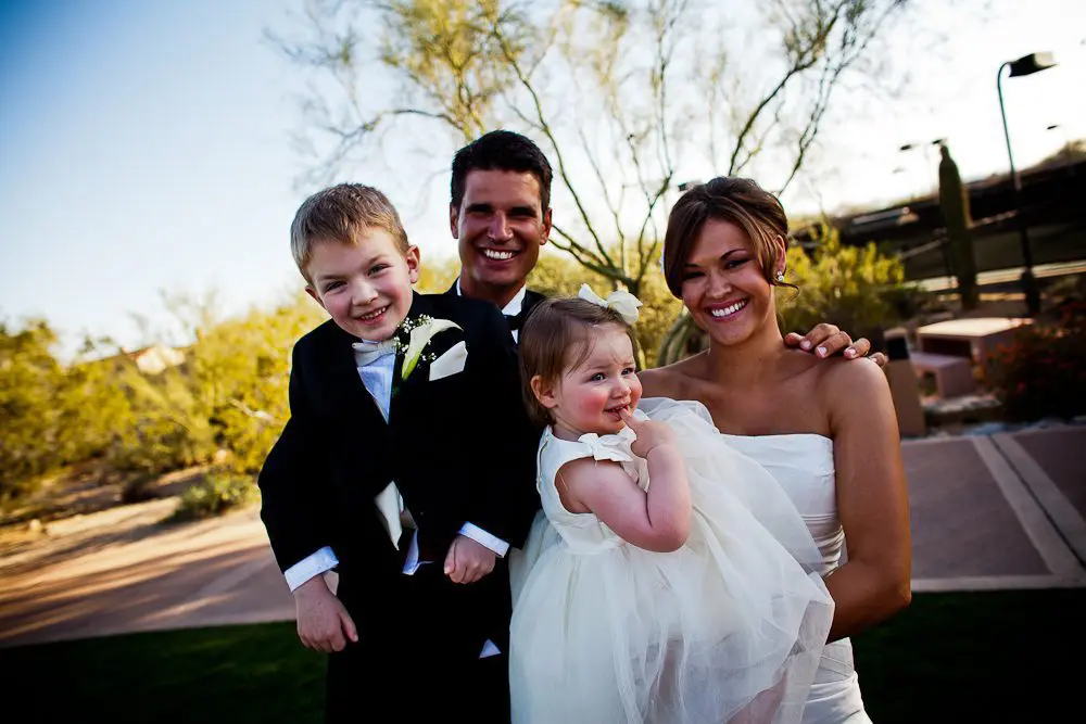 bride groom ring bearer and flower girl everyone smiling after the ceremony