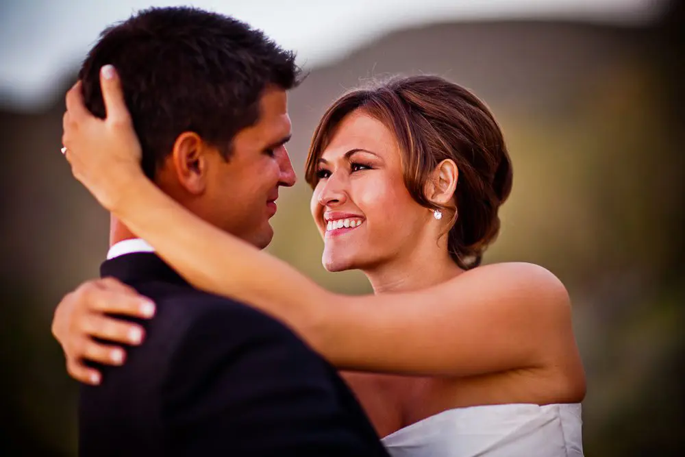 bride and groom smiling newly married couple gazing into each others' eyes