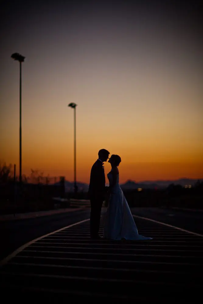 at sunset creative shot of bride and groom after wedding