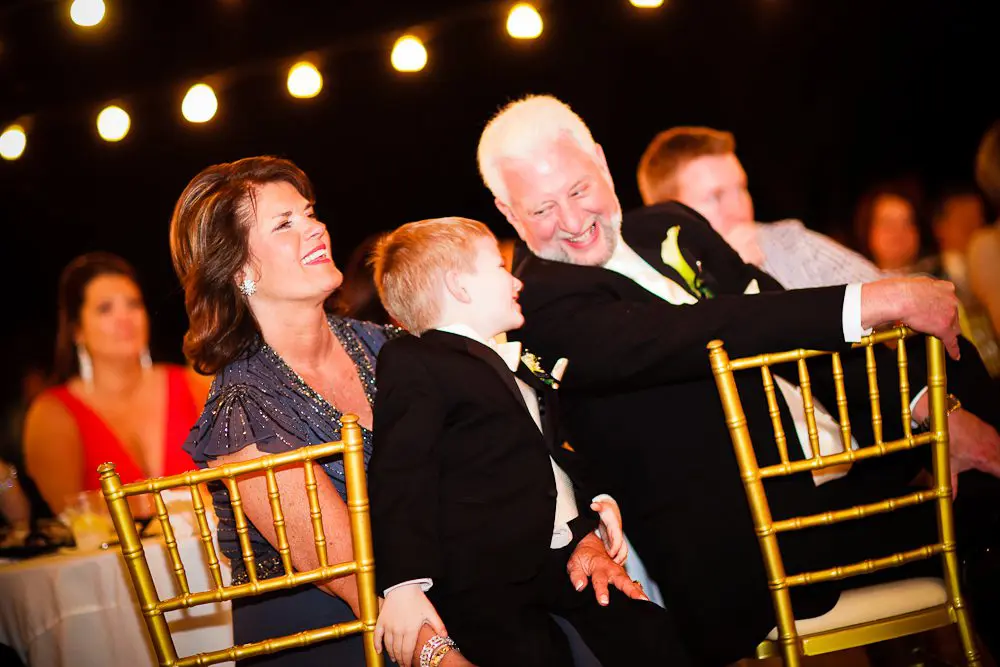 the ring bearer, mother / father of the groom the ring bearer and father of the bride having fun at the reception