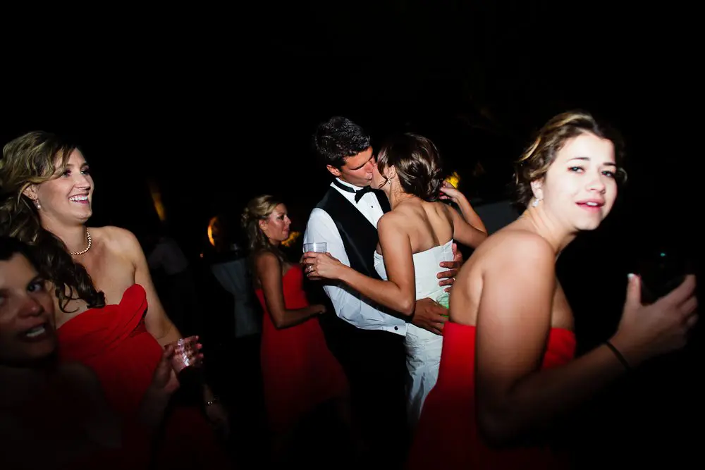 the bride and groom funny pic of bride and groom kissing at the reception