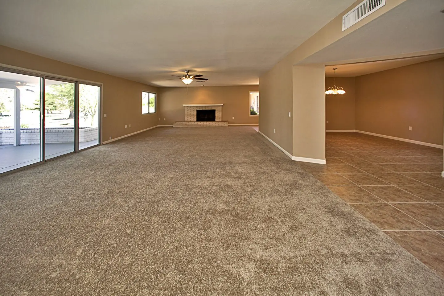 living room with fire place and view of dining room