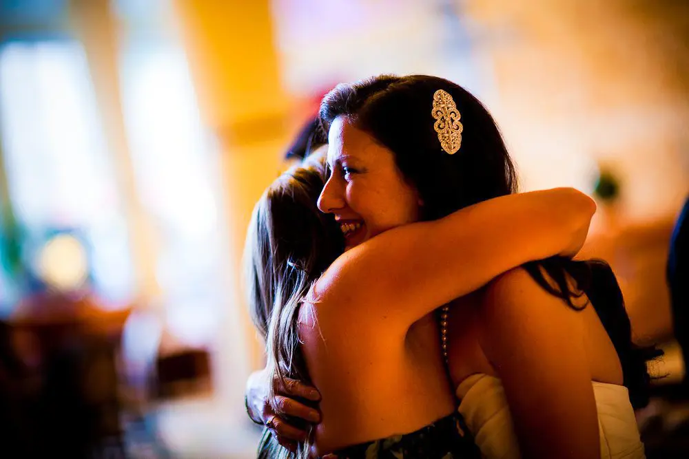 the bride hugs her guests