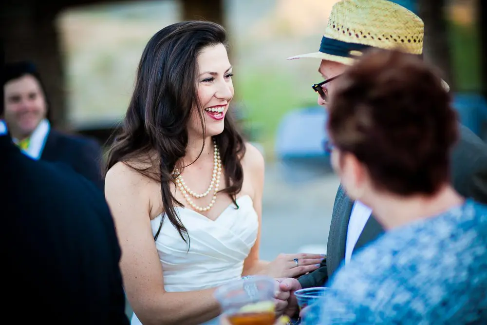 the bride laughing with a guest