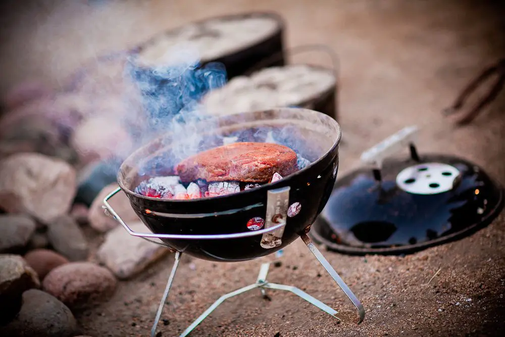 cooking steak on the coals