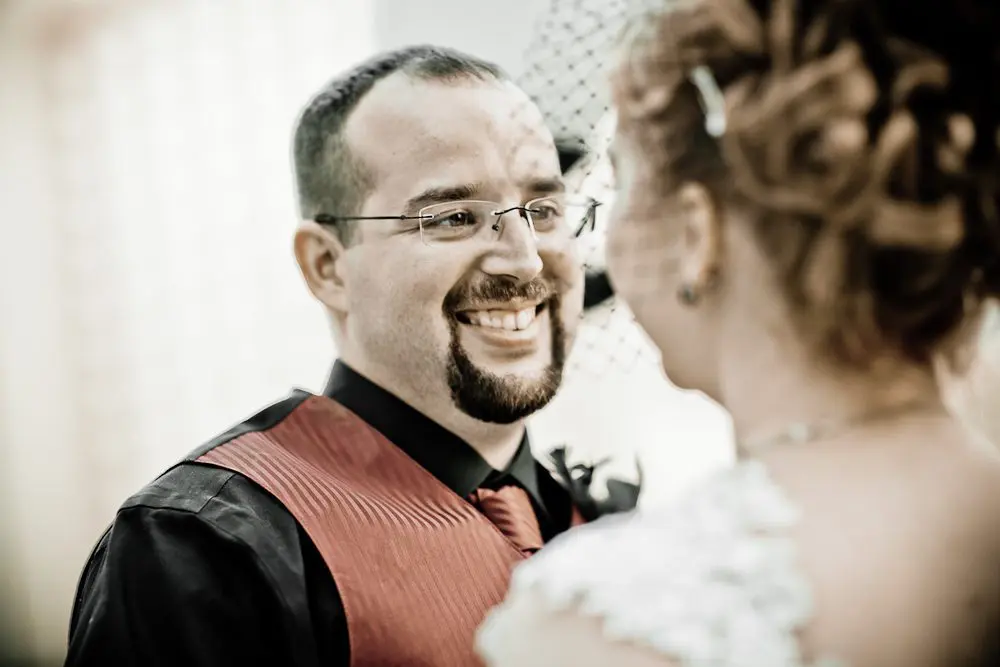 groom looking at the bride