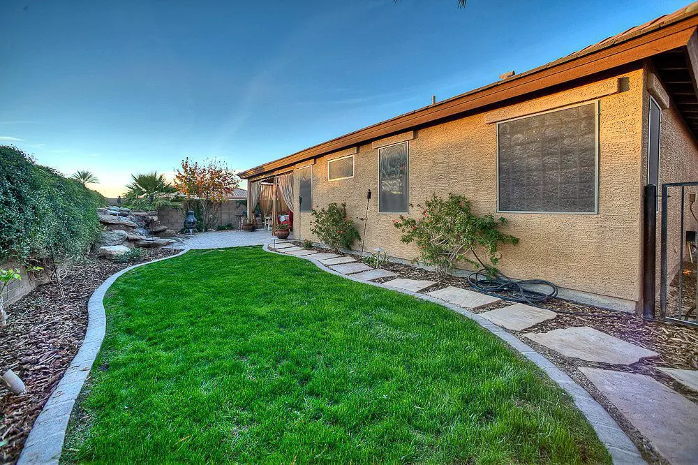 back view of house with grass lawn