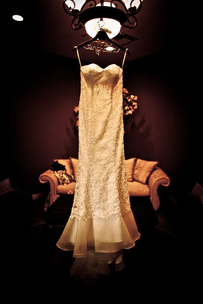 The wedding dress hanging in the bride's room