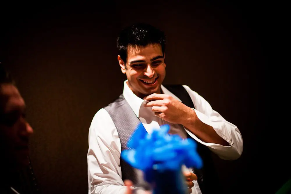 the groom laughing while giving gifts