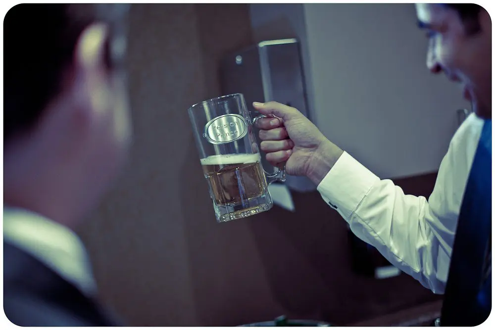 the groom admiring his beer mug gift