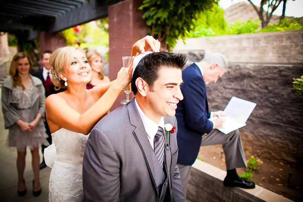 the bride putting on the groom's Yamaka