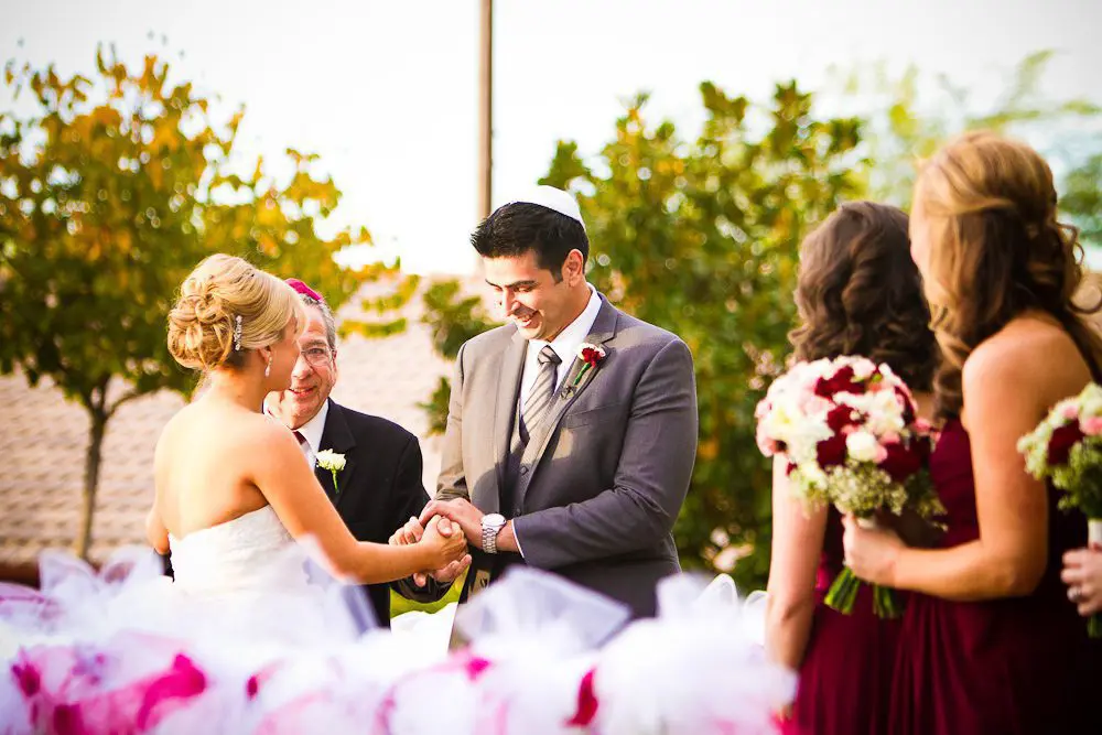 the father giving away the bride to the groom