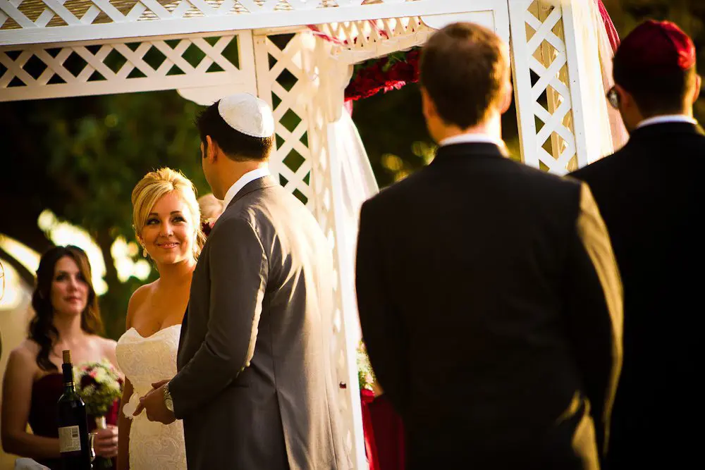 the bride smiling at the groom during the ceremony