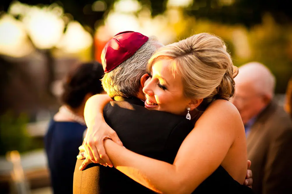 the bride hugs her father after the ceremony
