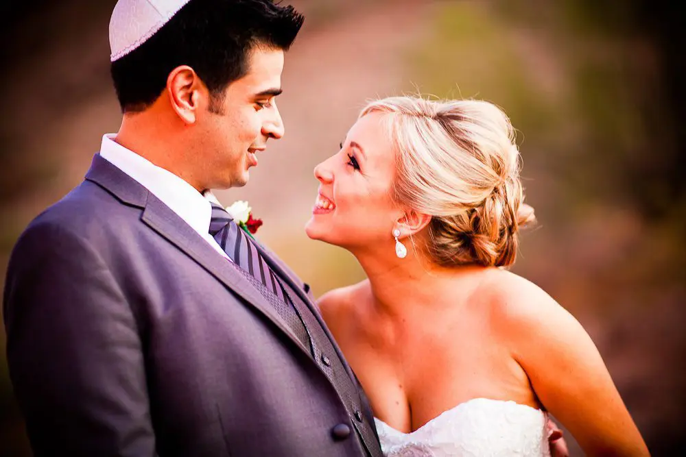 the bride and groom smiling at each other