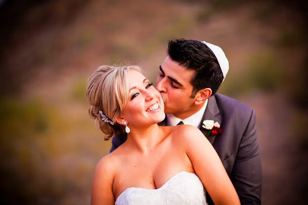 the groom kissing the bride's cheek