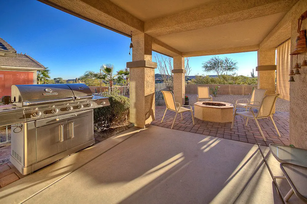back patio with fireplace and outdoor grill