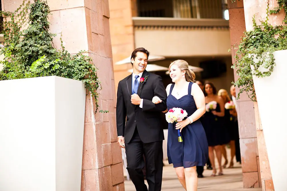 groomsman and bridesmaid walking down the aisle