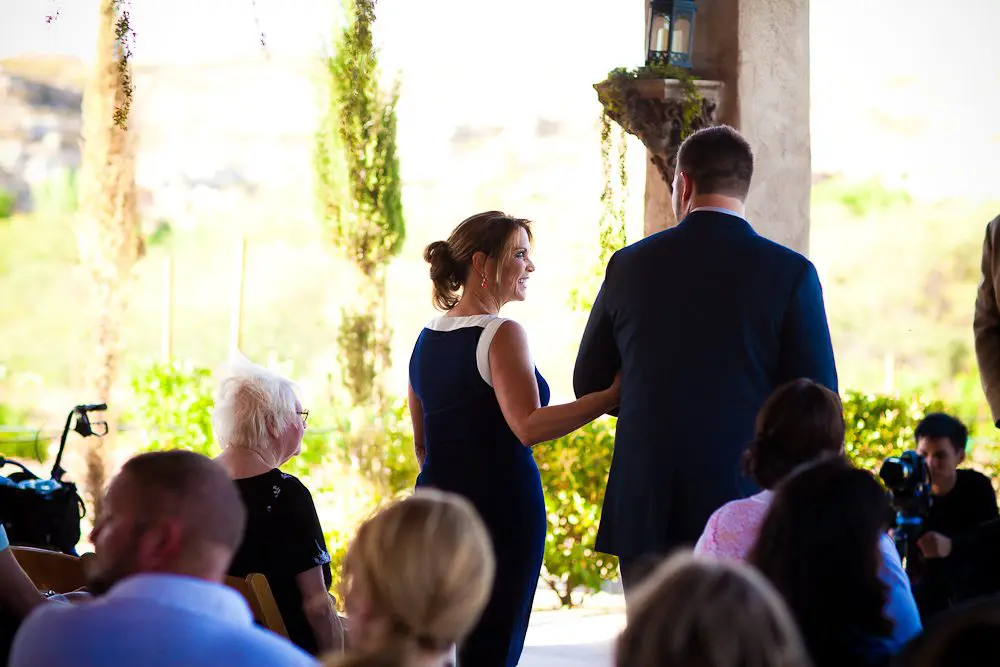 the mother of the bride walking down the aisle