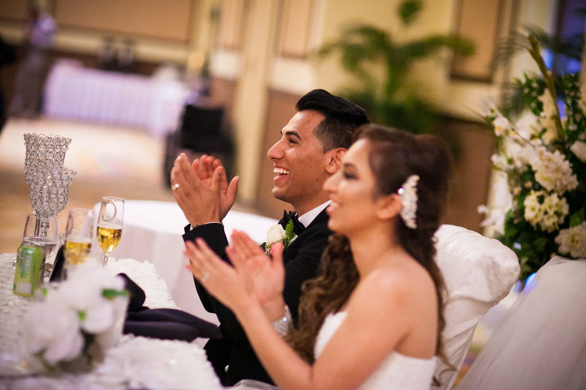 bride and groom listening to speeches