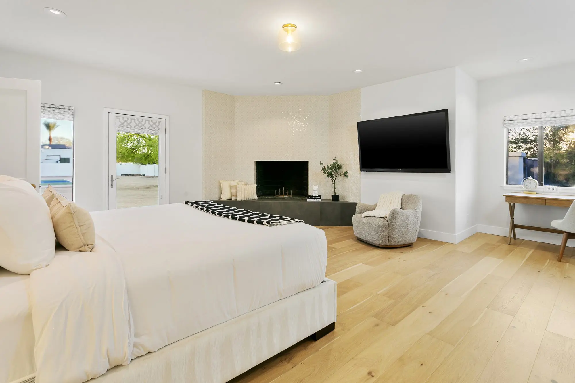 Guest bedroom with fireplace and media wall