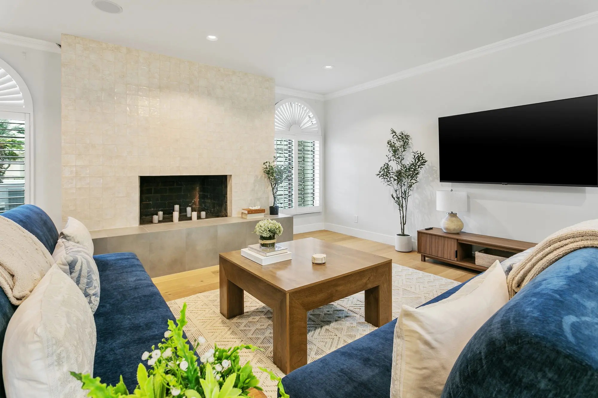 Family room with blue velvet sofas and fireplace
