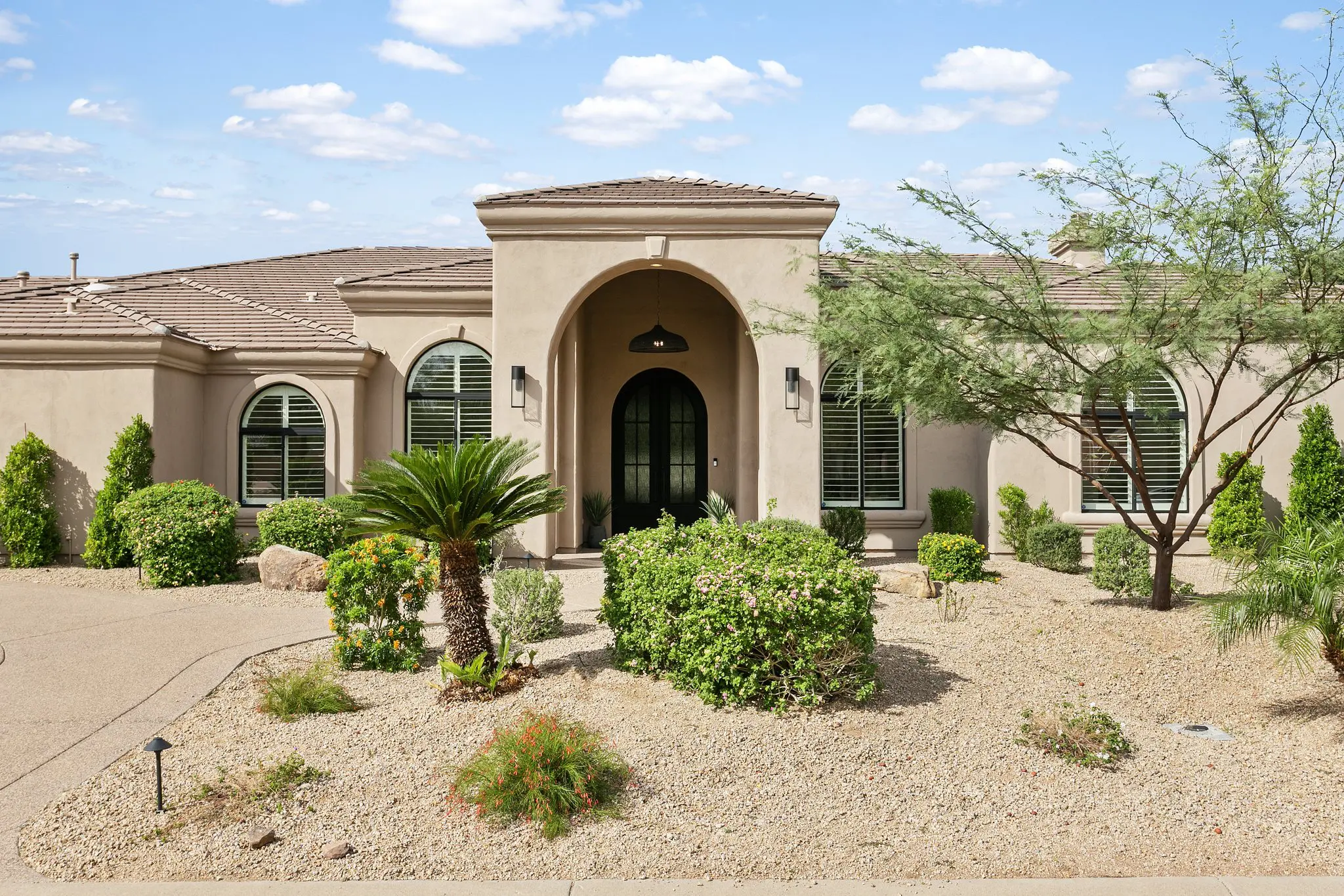 Catavina North Scottsdale luxury home front exterior with arched entry and desert landscaping