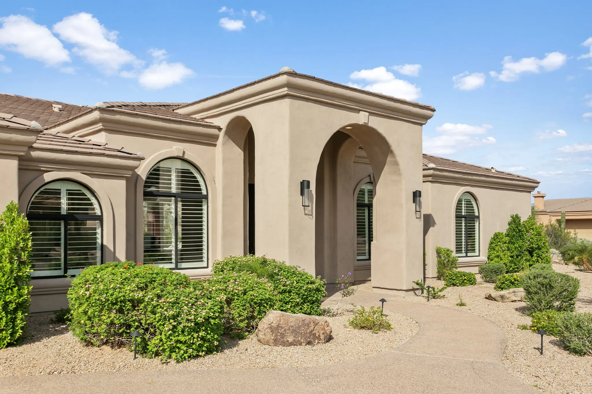 Scottsdale real estate photographer front elevation, arched windows and stucco entry