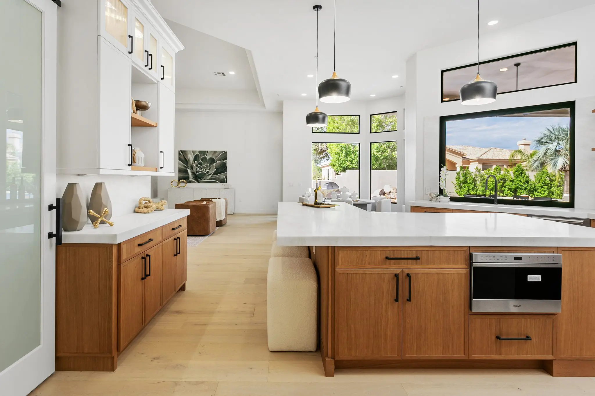 Kitchen island and wood cabinetry looking toward the backyard windows