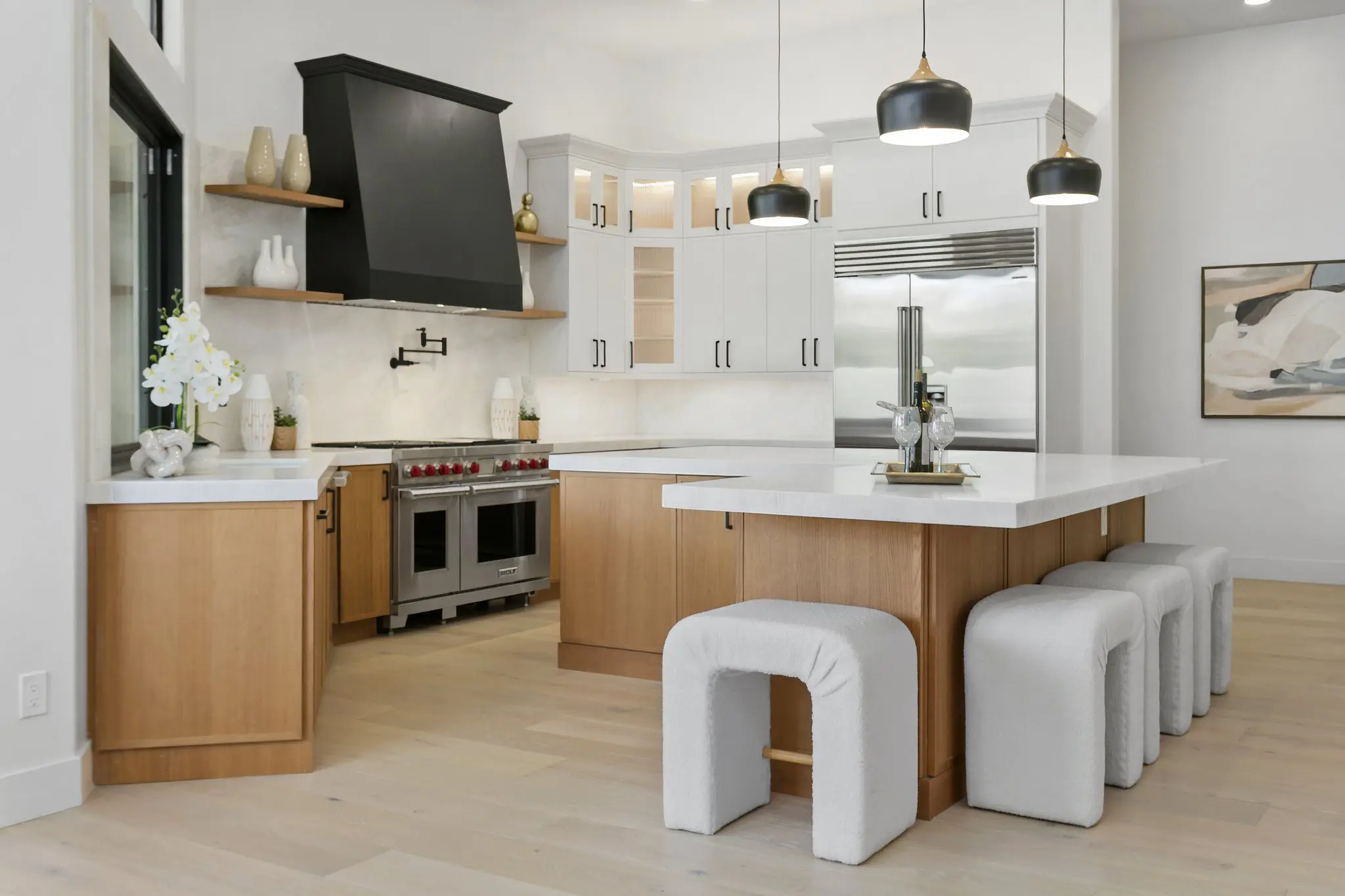 Kitchen with island seating, Sub-Zero refrigerator and glass-front cabinets