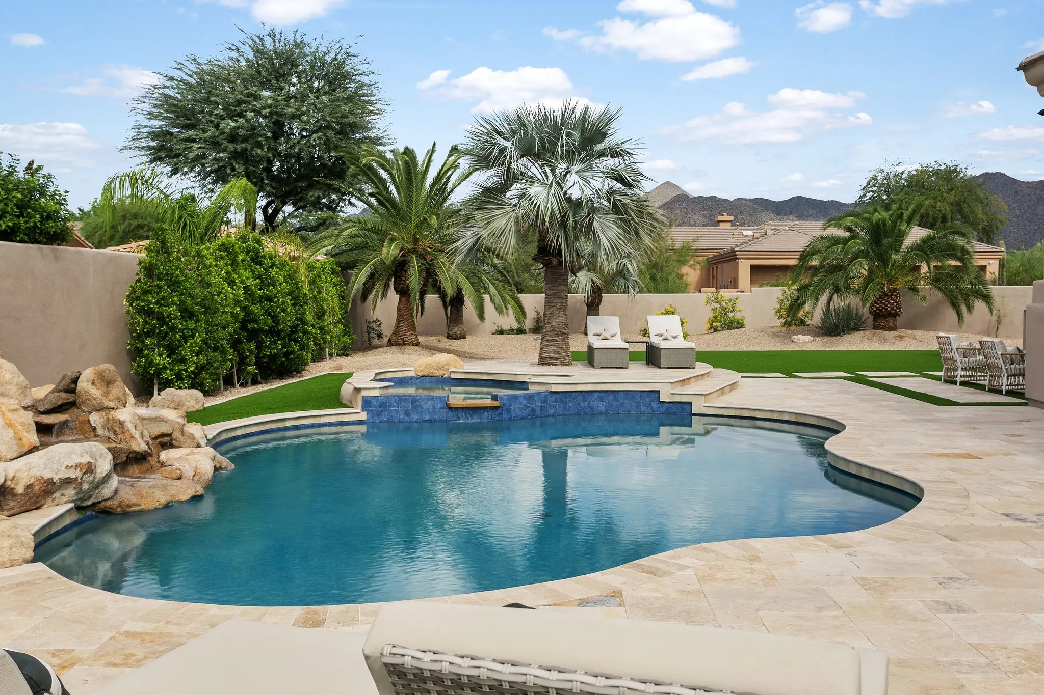 Free-form pool with boulder waterfall and McDowell Mountain views, Scottsdale real estate photographer