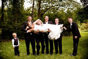 fun photo of groomsmen holding the bride