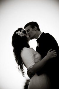 Black and white of photos of married couple kissing