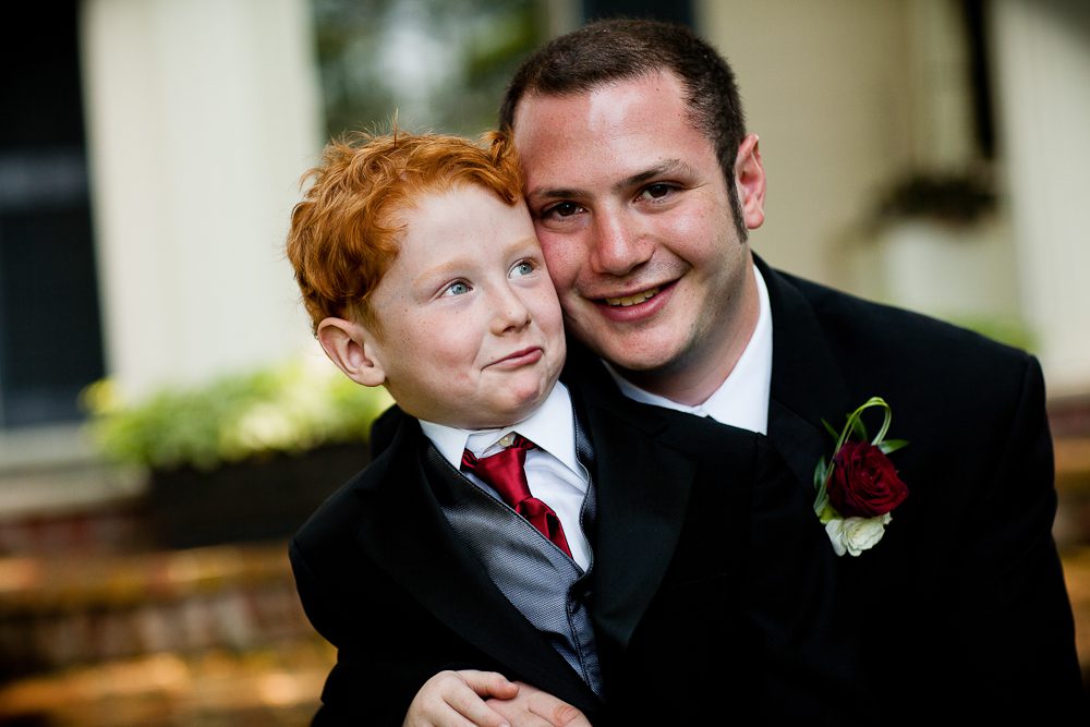 funny shoot of groom and ring bearer