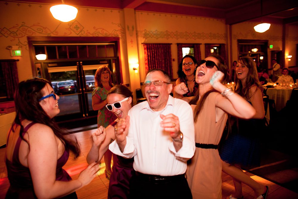father having a great time dancing at the reception