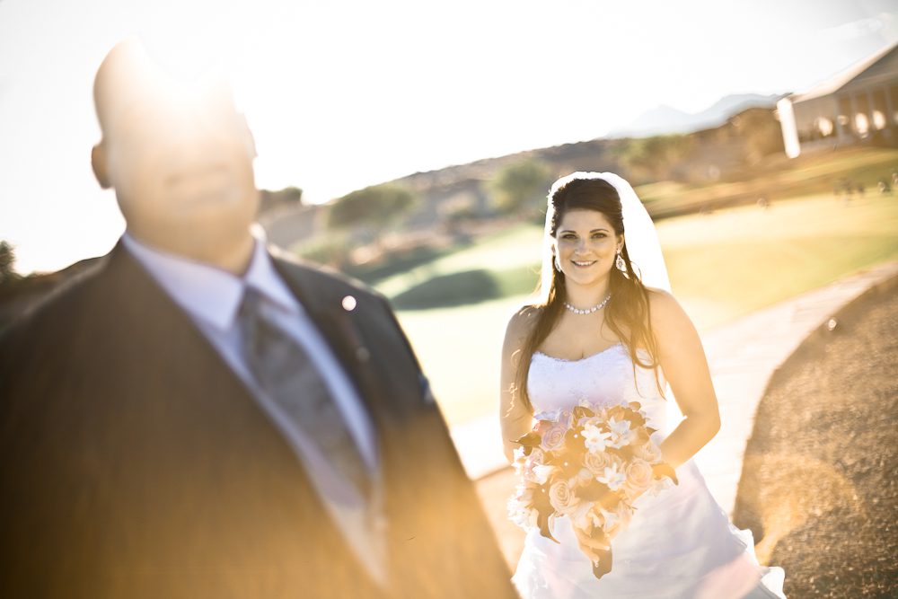 artistic photograph of bride with groom out of focus