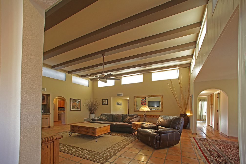 open living room with exposed beams and great light