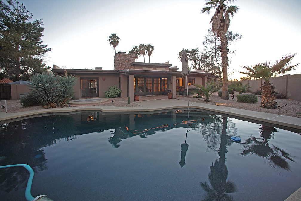 the pool and patio at sunset