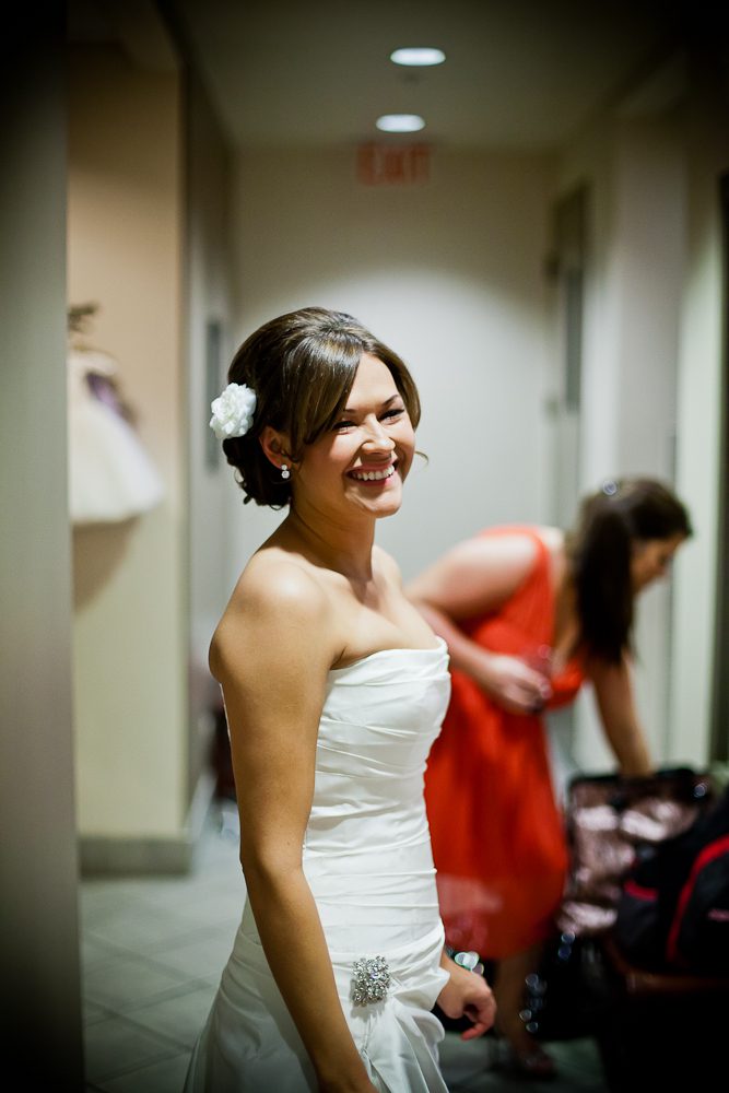 Bride smiling while getting ready with the bridesmaids