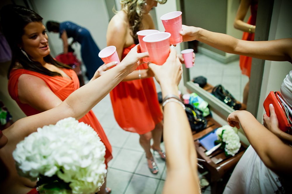The bride and bridesmaids having a toast before the wedding
