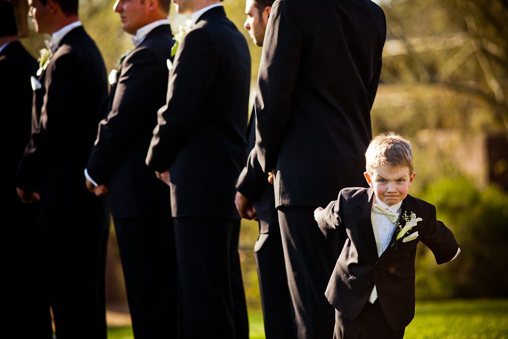 the ring bearer with the groomsmen making a funny face